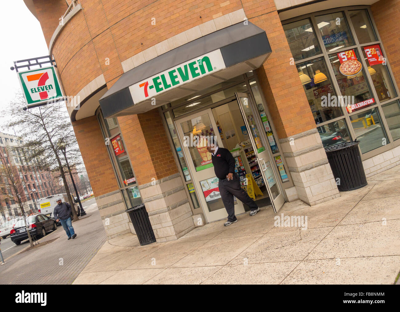 ARLINGTON, VIRGINIA, USA - Man leaving 7-eleven convenience store in Clarendon neighborhood. Stock Photo