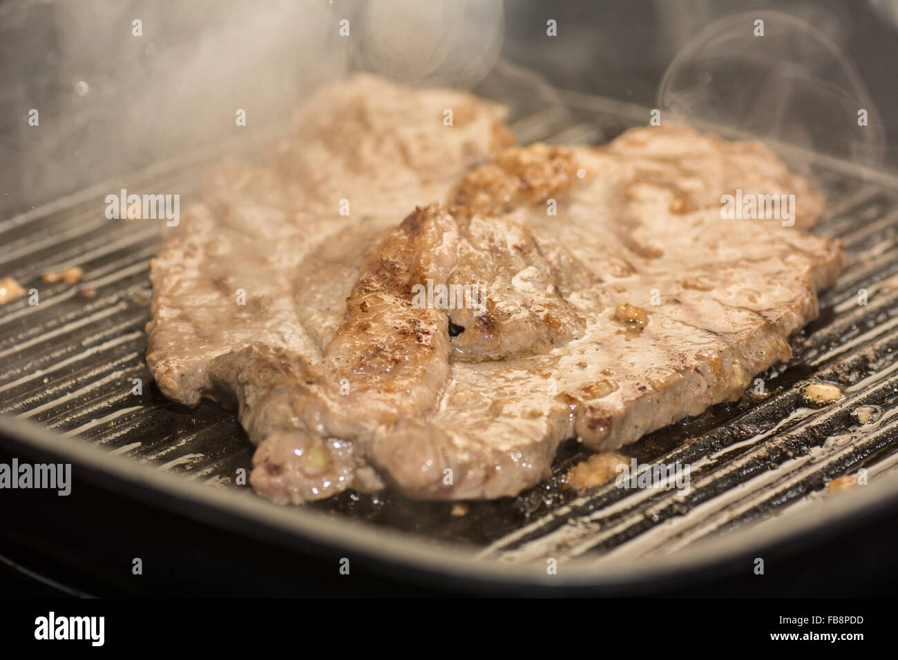 A Steak Frying Stock Photo