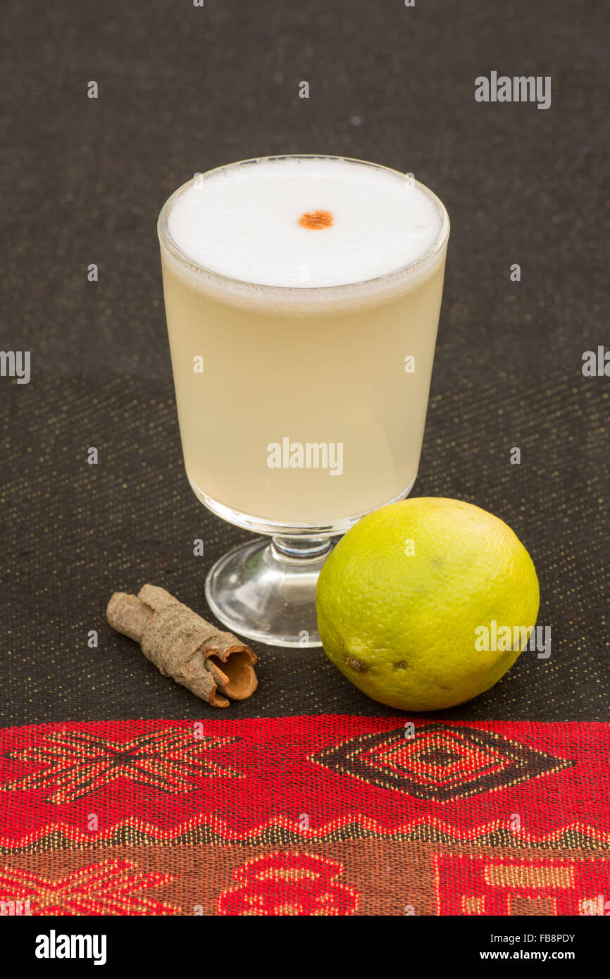Pisco Sour - traditional Peruvian cocktail made from Pisco, lime juice, bitters, sweet syrup and the white of an egg. Stock Photo