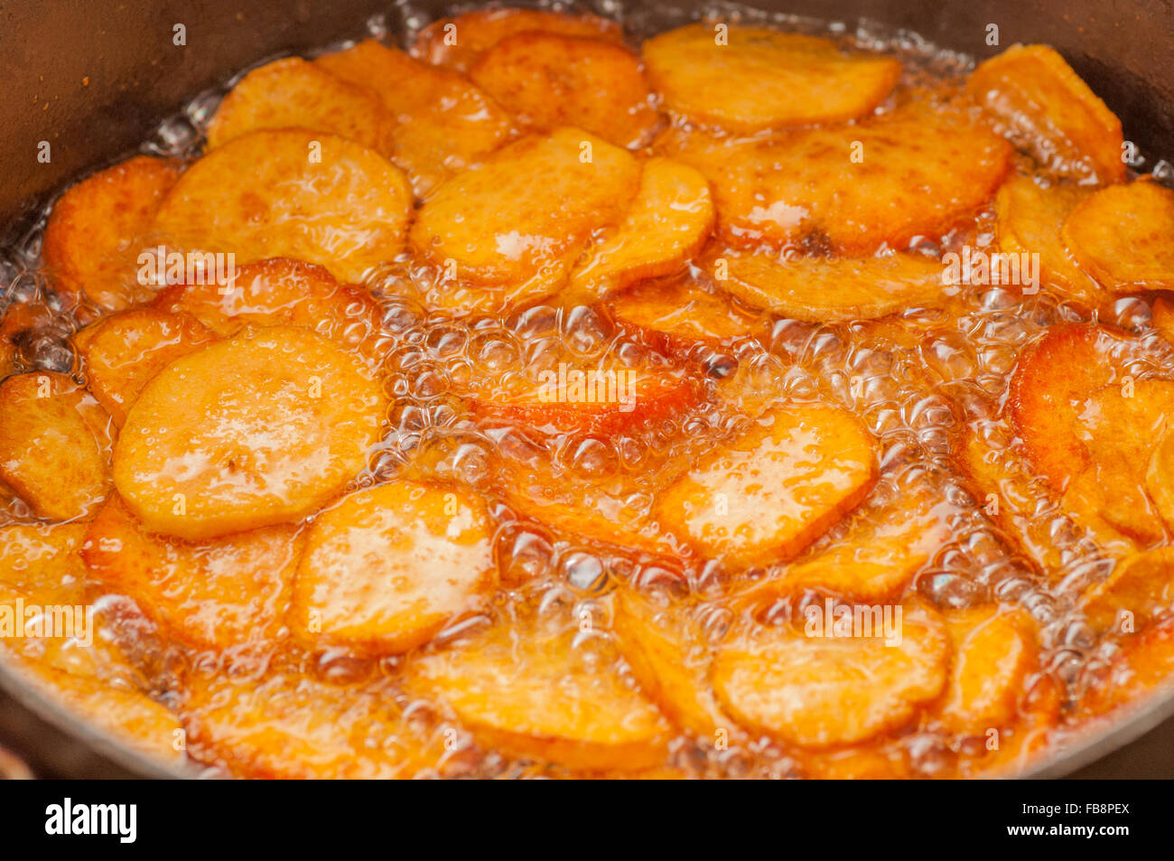 Deep Frying Sweet Potato slices - a typical Peruvian dish Stock Photo