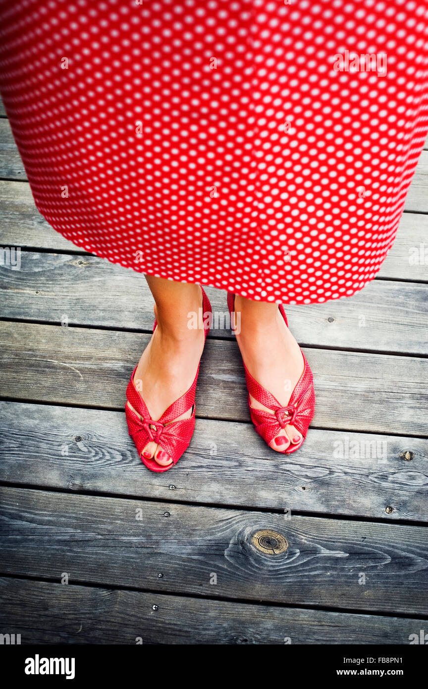 Sweden, Uppland, Woman standing on wood Stock Photo