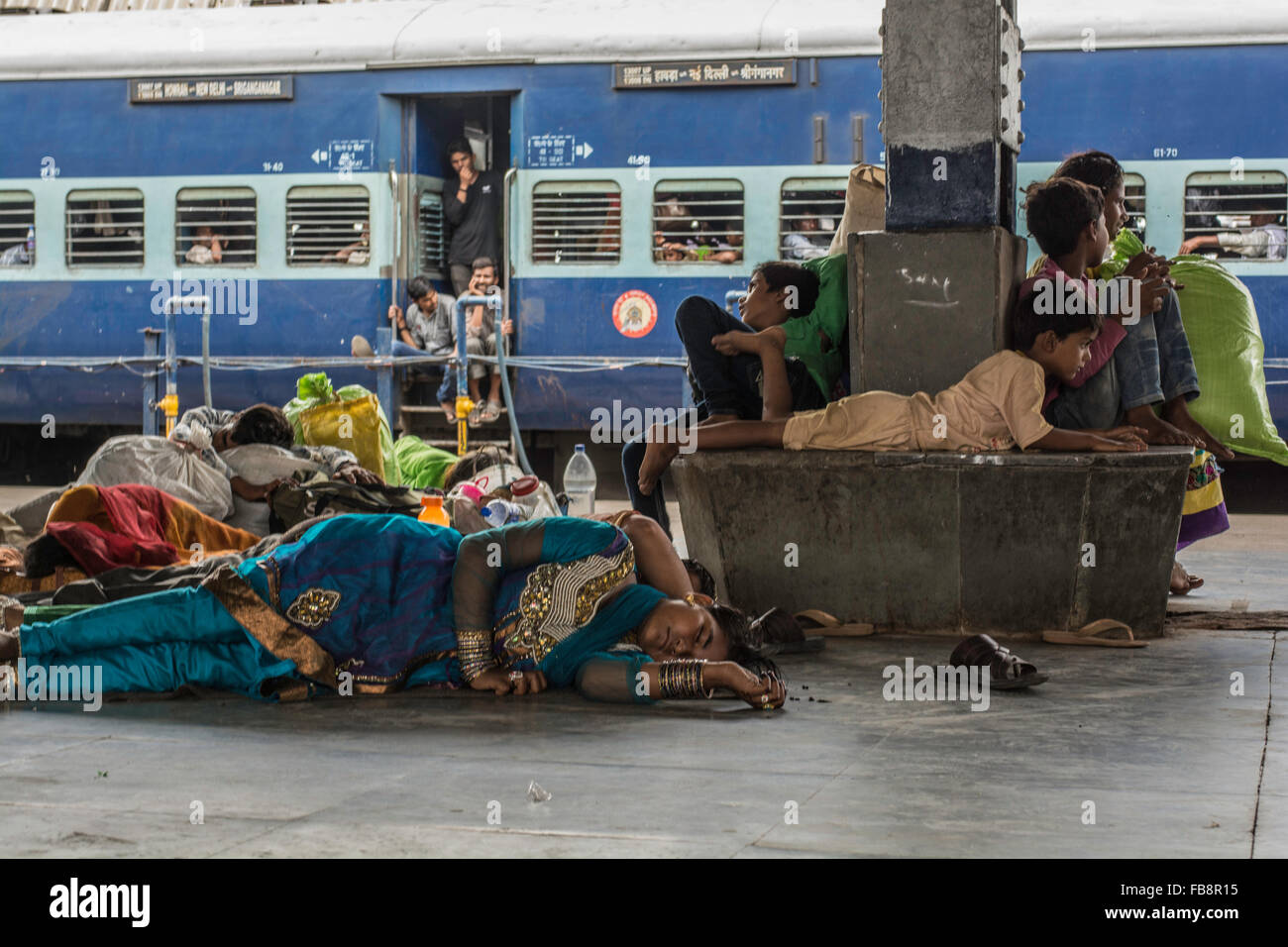 Passengers sleeping or waiting for the train in railway station. Indian
