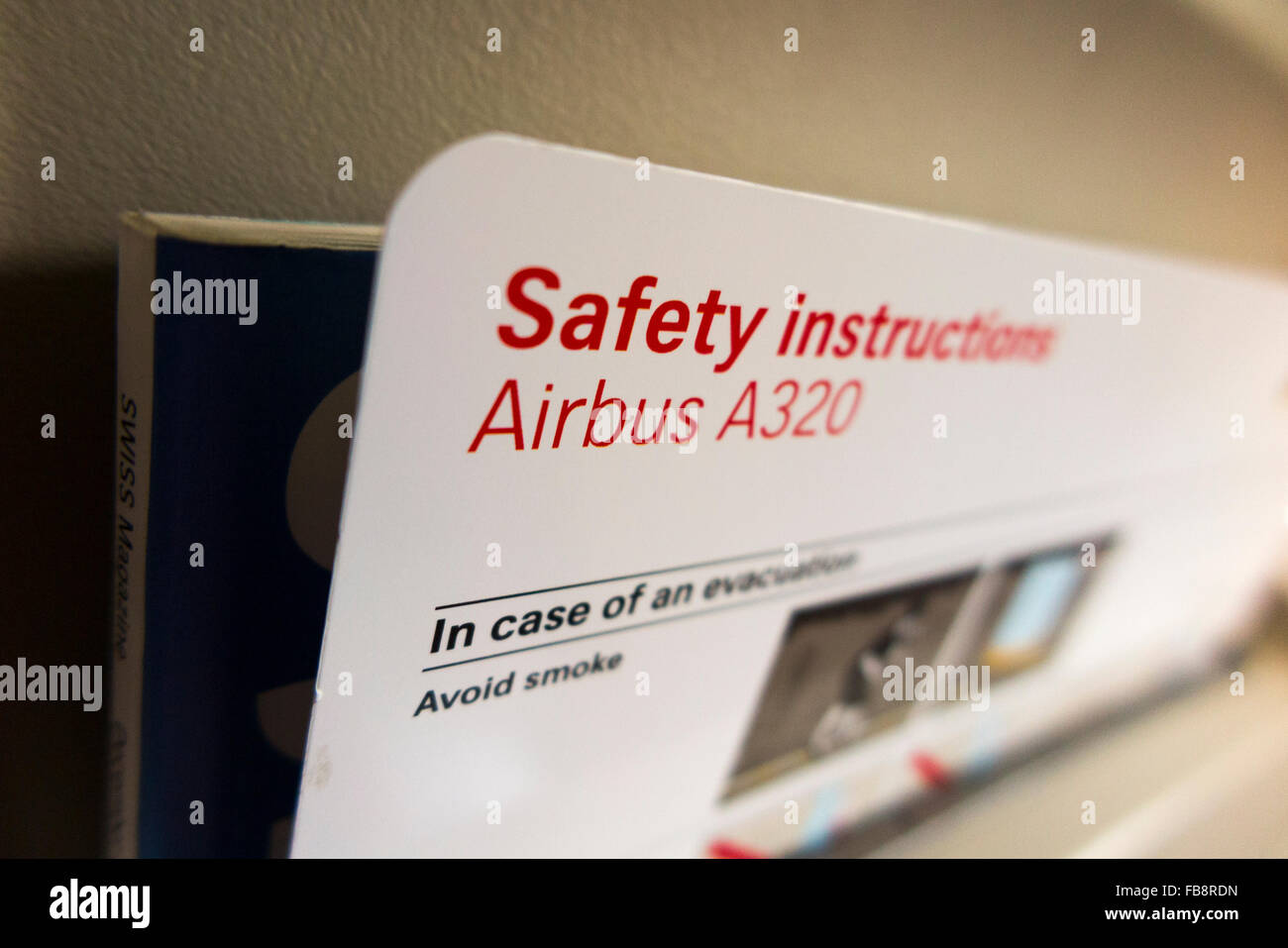 Aircraft safety and emergency information instruction / guide card during a flight in an A320 plane / aeroplane / airplane. Stock Photo