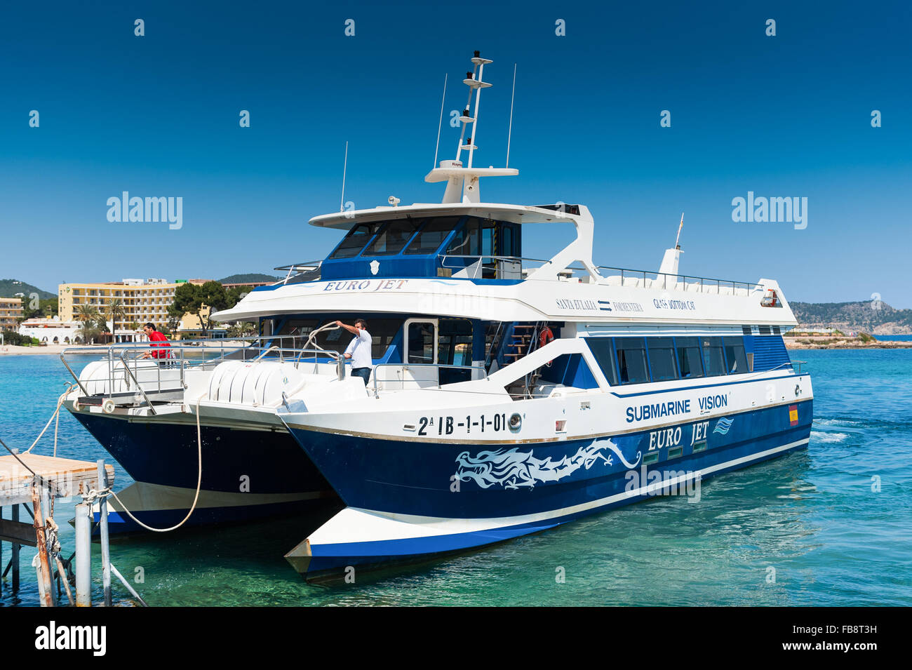 Glass bottom boat pulling into the harbour to pick up passengers  in Ibiza, Balearic Islands, Spain Europe. Stock Photo