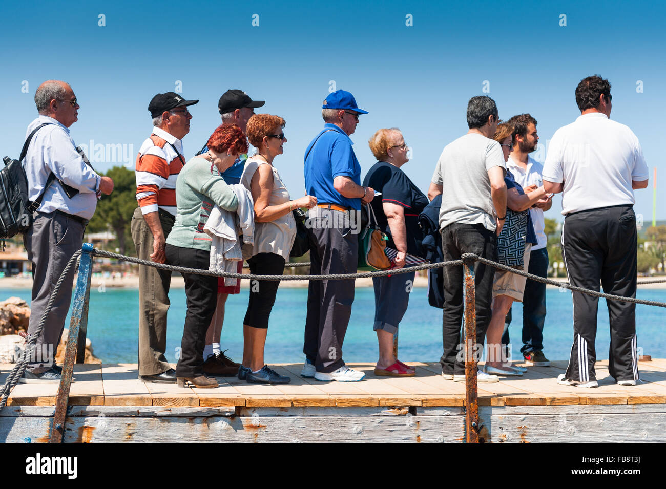 A queue of tourists wait to board a ferry on the Island of Ibiza, Balearic Islands,Spain, Europe Stock Photo