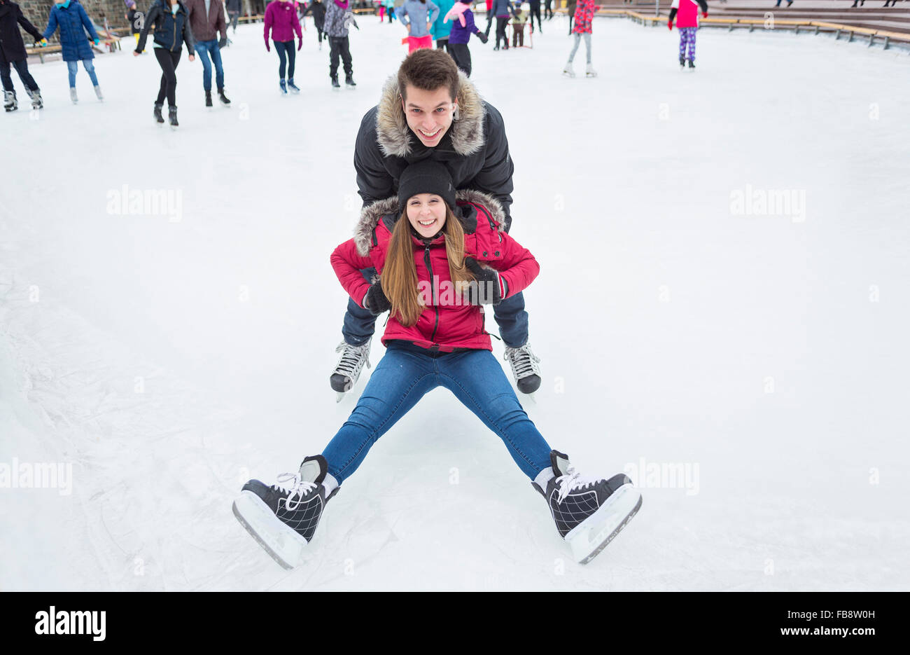 Ice skating couple having winter fun on ice skates Quebec, Canada Stock