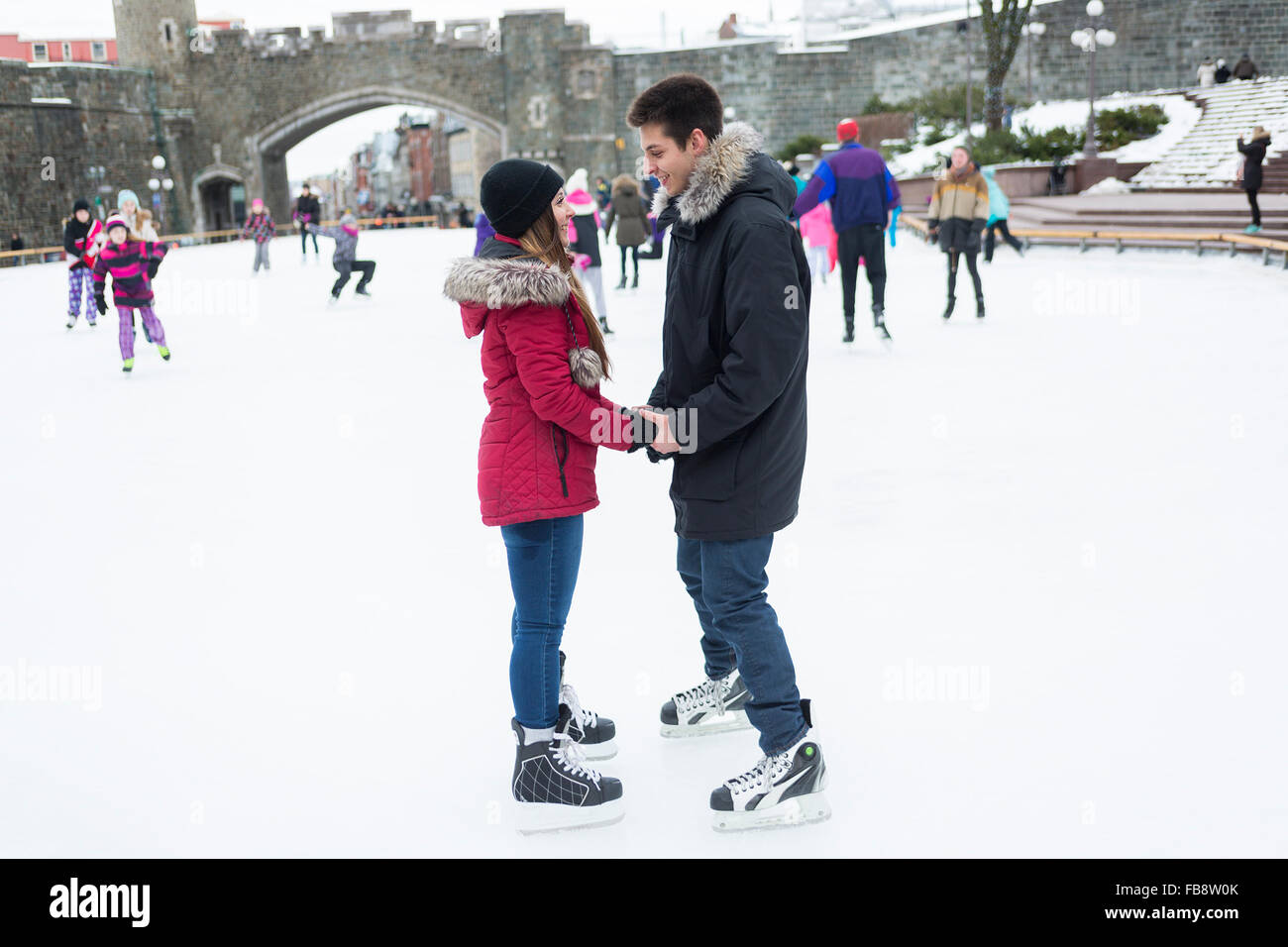 Ice skating couple having winter fun on ice skates Quebec, Canada Stock