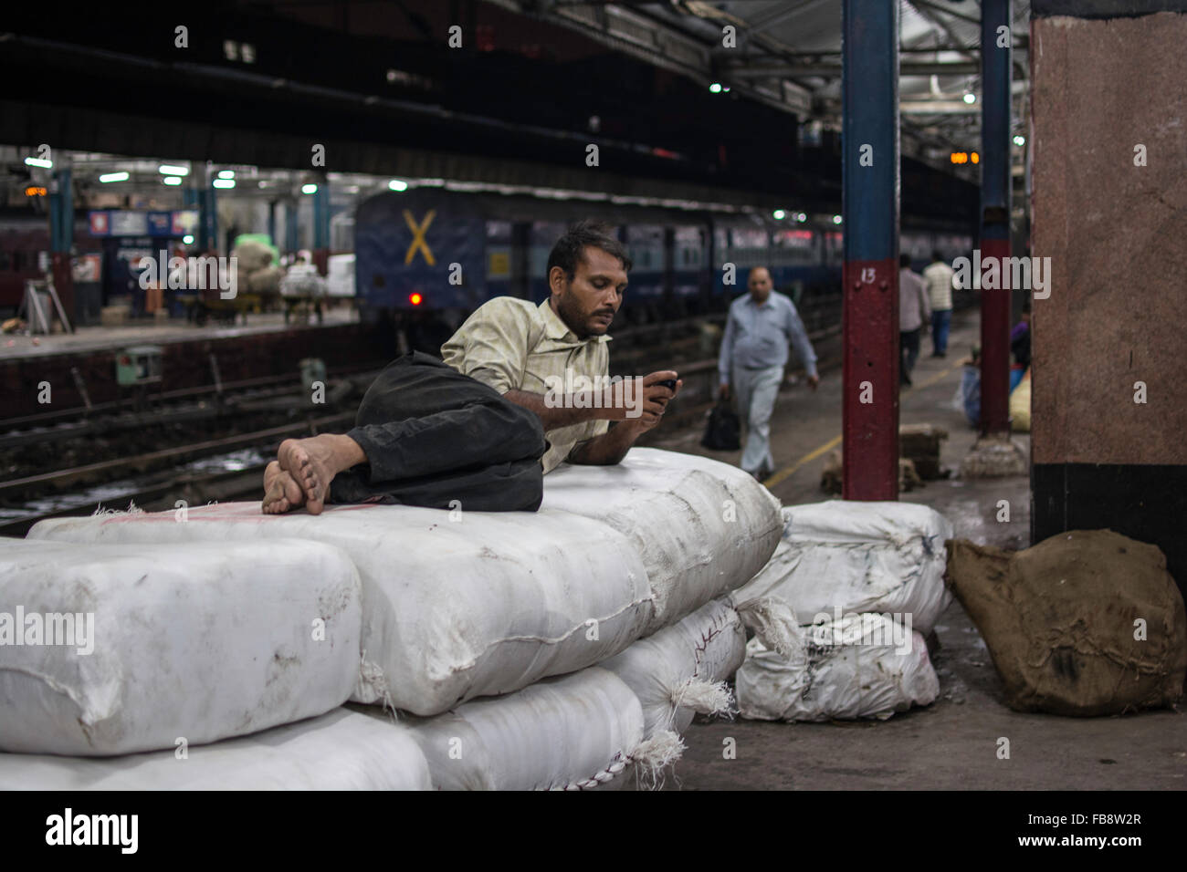 Passengers sleeping or waiting for the train in railway station. Indian Railways, India. Stock Photo