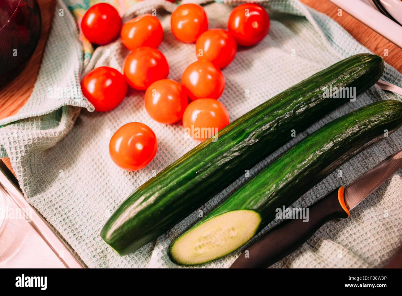 Cherry tomatoes and cucumbers closeup. Stock Photo