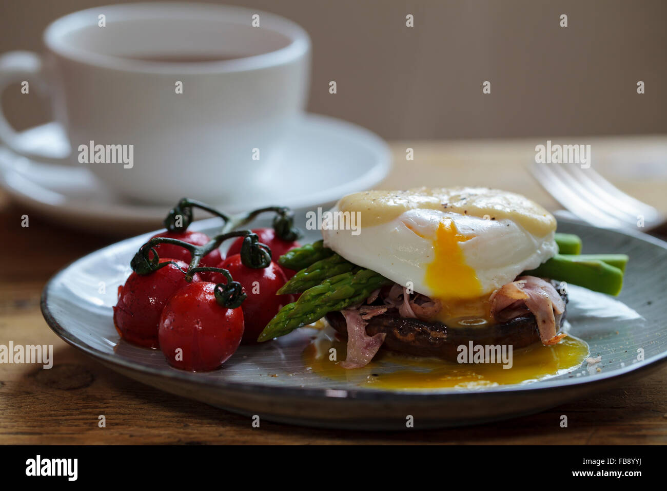 Breakfast with mushroom, poached egg, asparagus and roast tomatoes