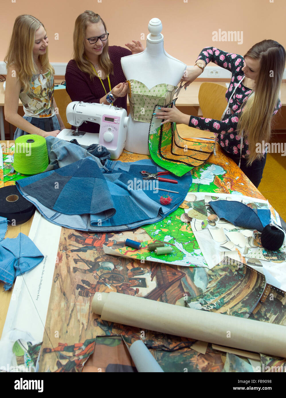 Bad Lauchstaedt, Germany. 11th Jan, 2016. Under the direction of the Schule fuer Mode und Design fashion school in Magdeburg, pupils Alina, Saskia and Lea (l-r) from the Goethe Schule in Bad Lauchstaedt make clothes for their new collection at Fashion Week, in Bad Lauchstaedt, Germany, 11 January 2016. The 40-minute show is due to take place in Berlin on 17 January. Photo: Hendrik Schmidt/ZB/dpa/Alamy Live News Stock Photo