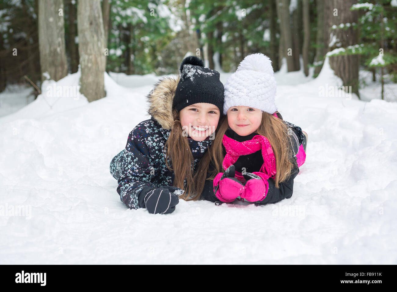 Two girls looking at camera in winter park Stock Photo - Alamy