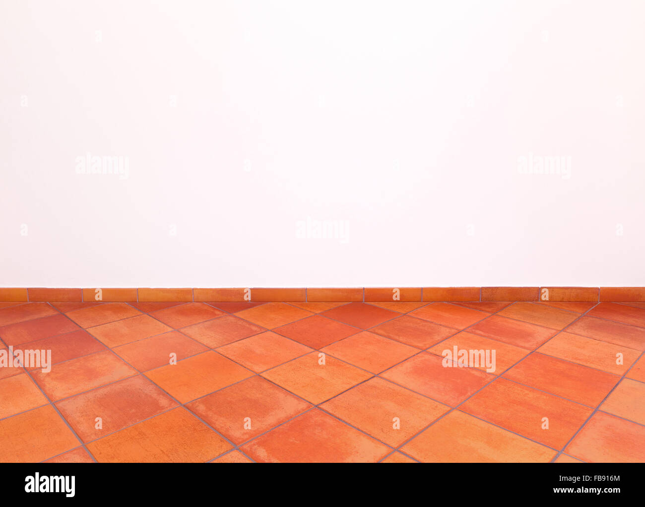 Tuscan traditional old and grunge floor, red tiles and white wall. Italian rural interior empty room. Stock Photo