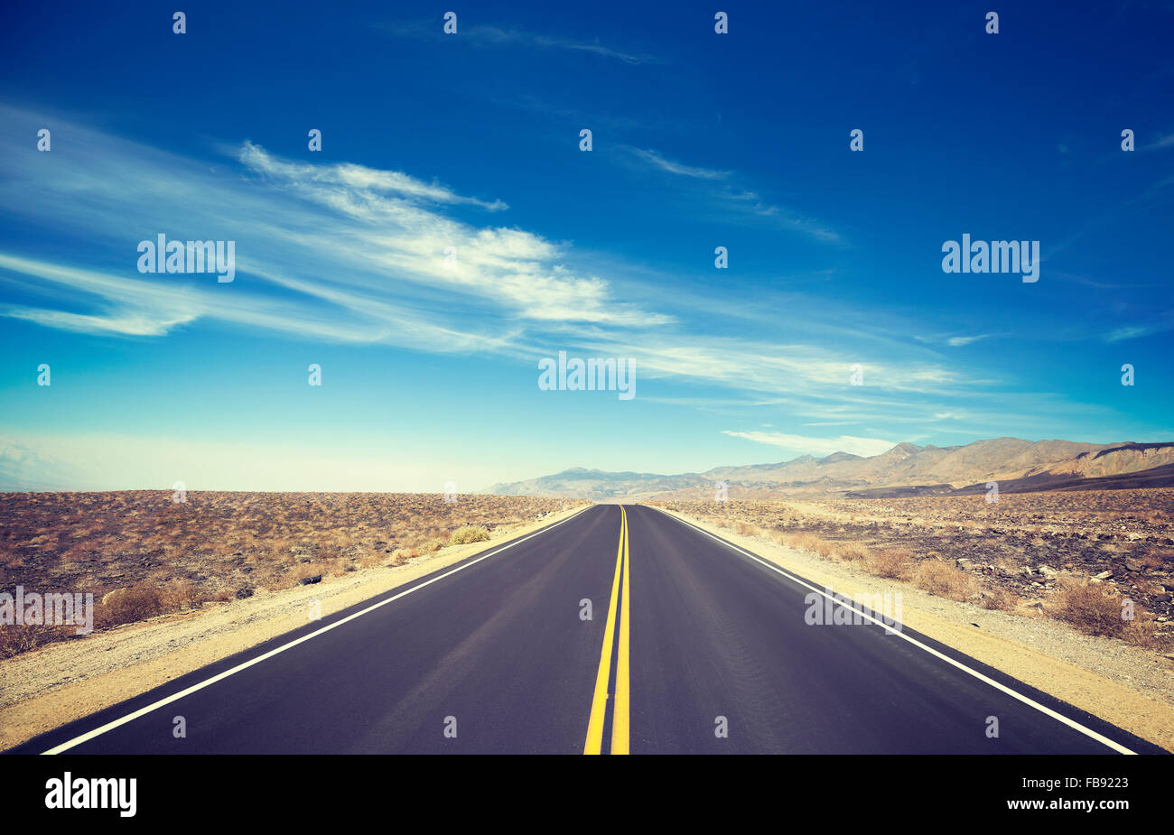 Vintage toned endless country highway, Death Valley, USA. Stock Photo