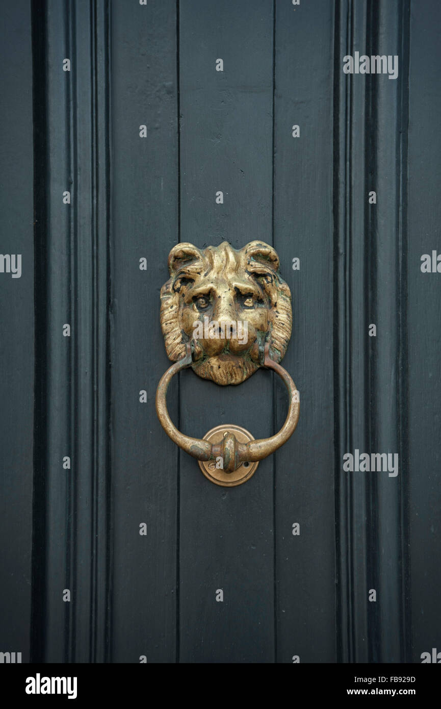 Old fashioned metal door knocker on painted door Stock Photo Alamy