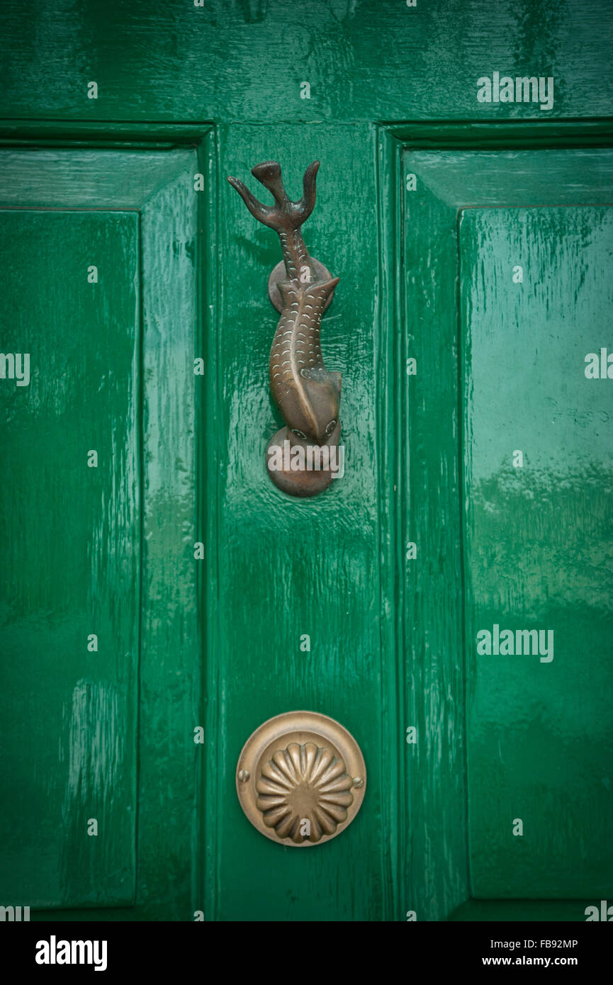 Old fashioned metal door knocker on painted door Stock Photo Alamy