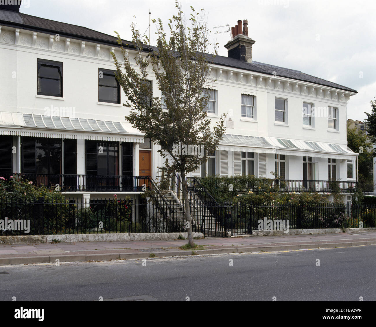 Exterior of a terrace of white Victorian town houses with verandas Stock Photo