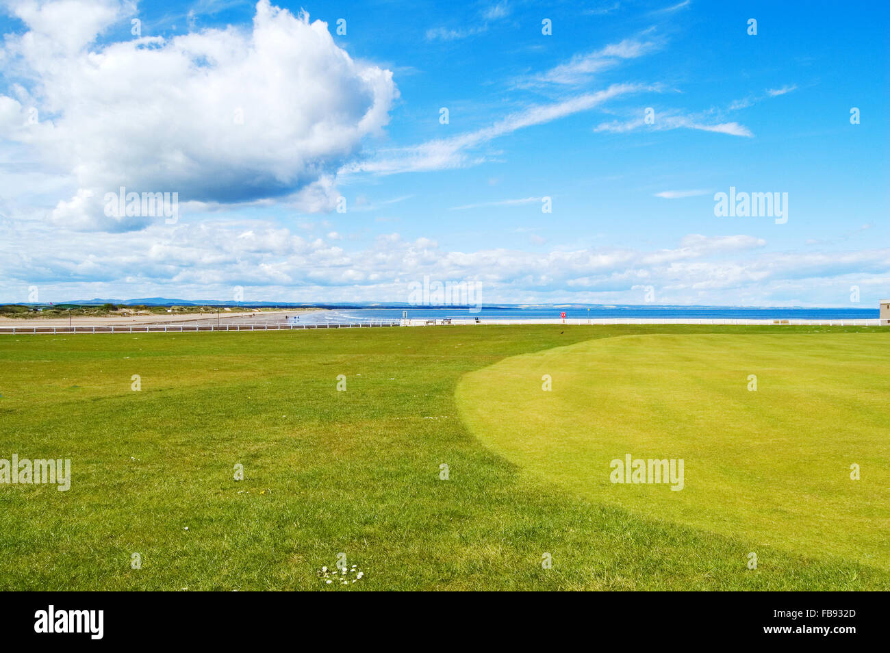 Golf green St Andrews old course links, on background West Sands beach movie location Chariots of Fire. Fife, Scotland, Uk, Euro Stock Photo