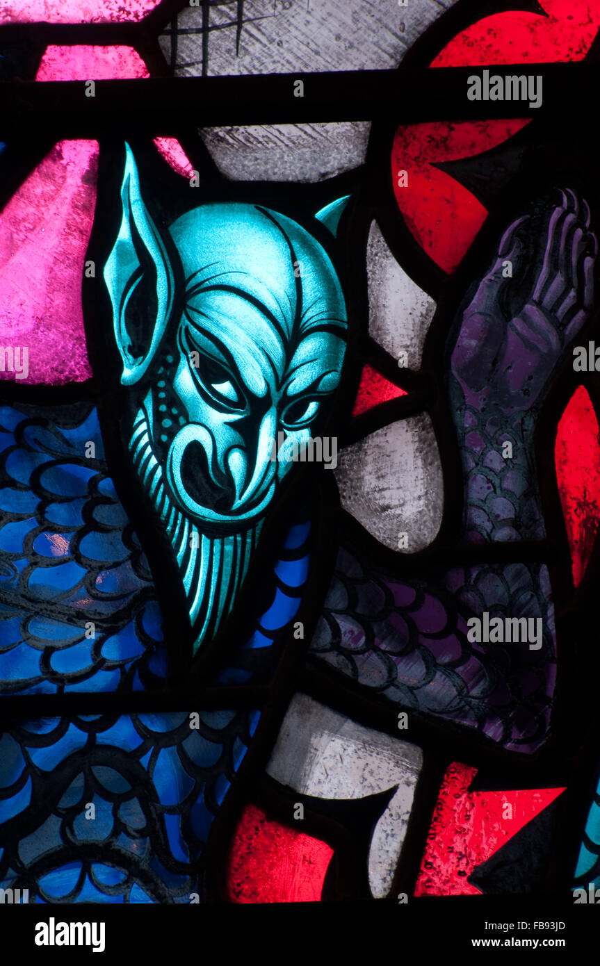 Devil depicted in stained glass window Stock Photo