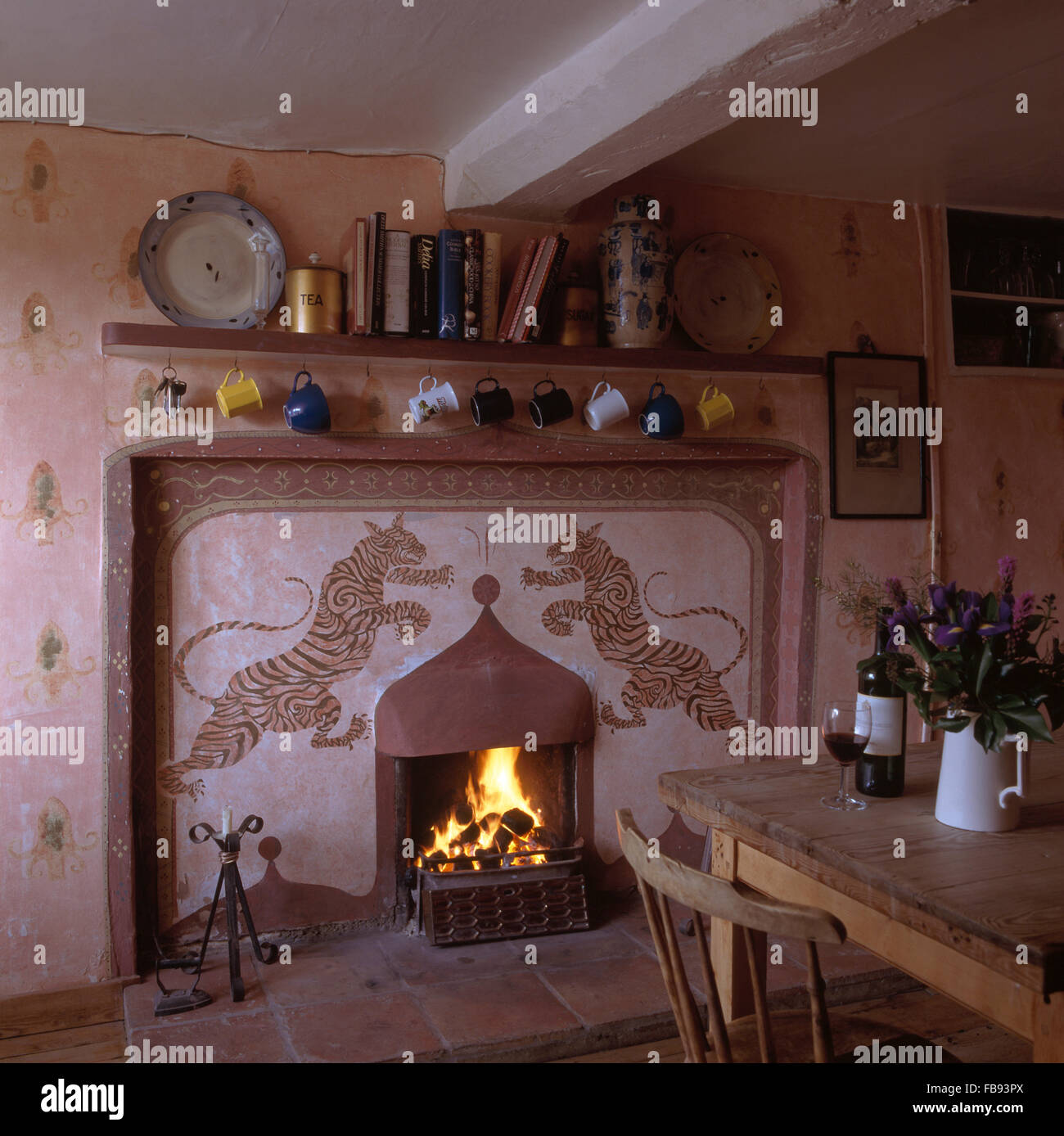 Stenciled tigers on fireplace in cottage dining room Stock Photo - Alamy