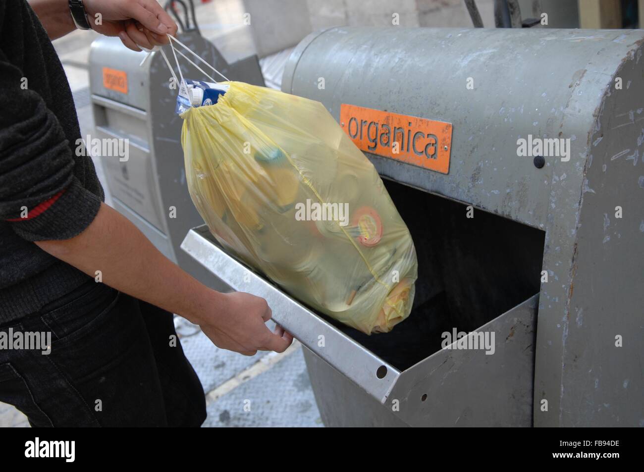man taking out trash in malaga central Stock Photo