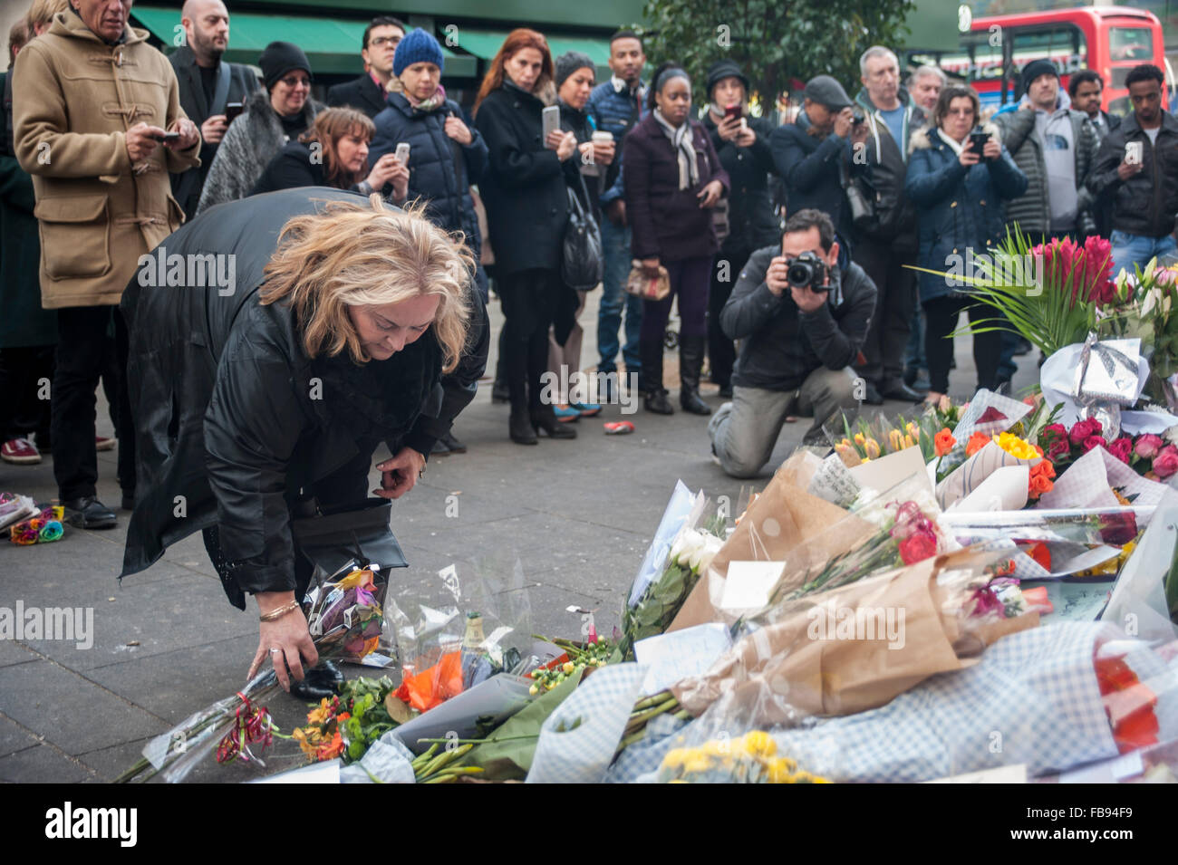 London, UK.  12 January 2016.  Fans continue to visit the mural of David Bowie in Brixton to pay their respects and leave tributes following news that the iconic 69 year old singer had died of cancer the previous day.   Credit:  Stephen Chung / Alamy Live News Stock Photo