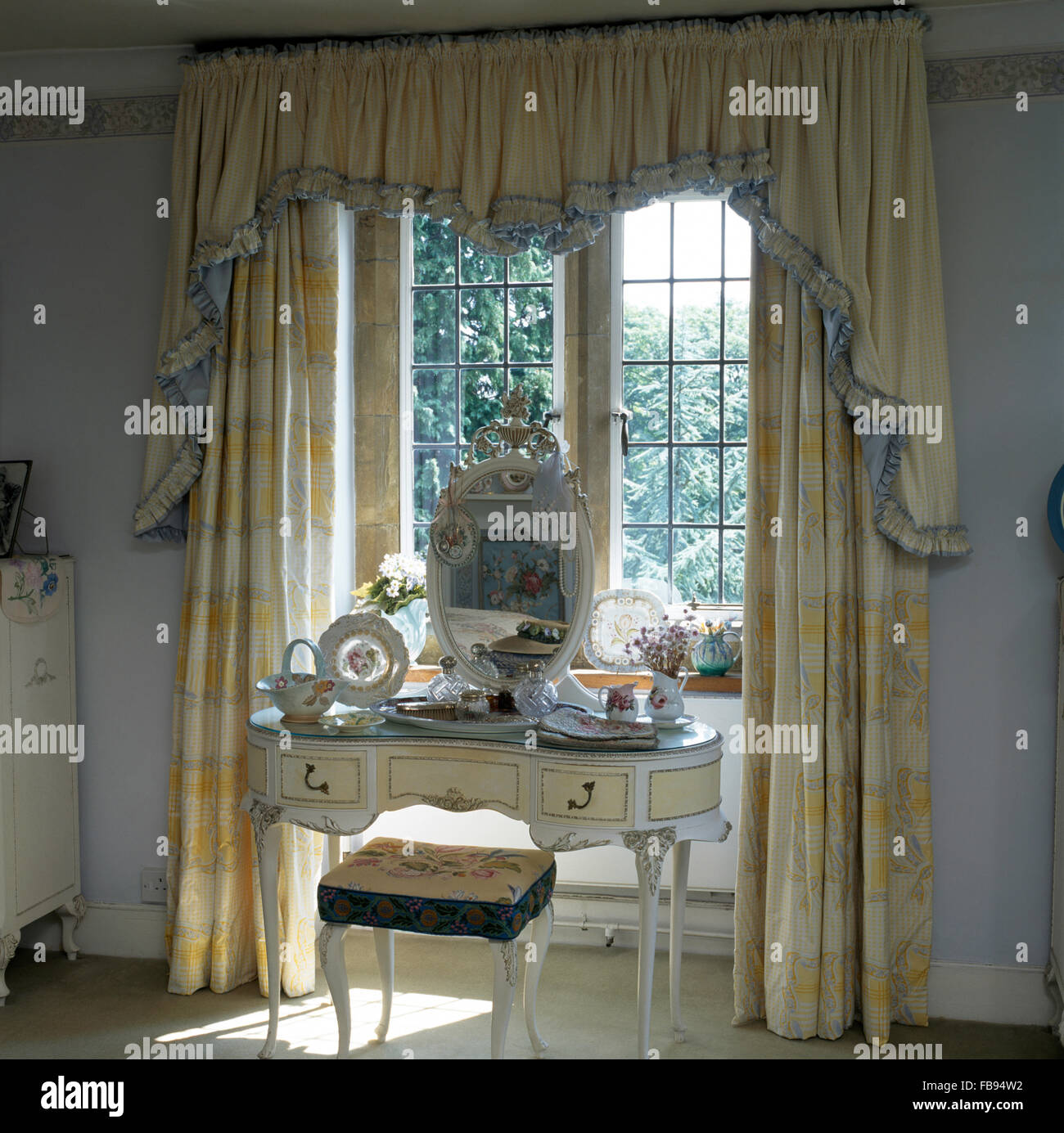 Oval Mirror On White Painted Dressing Table In Bedroom Window With