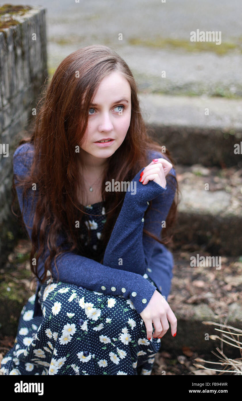 Female seated outdoors hi-res stock photography and images - Alamy