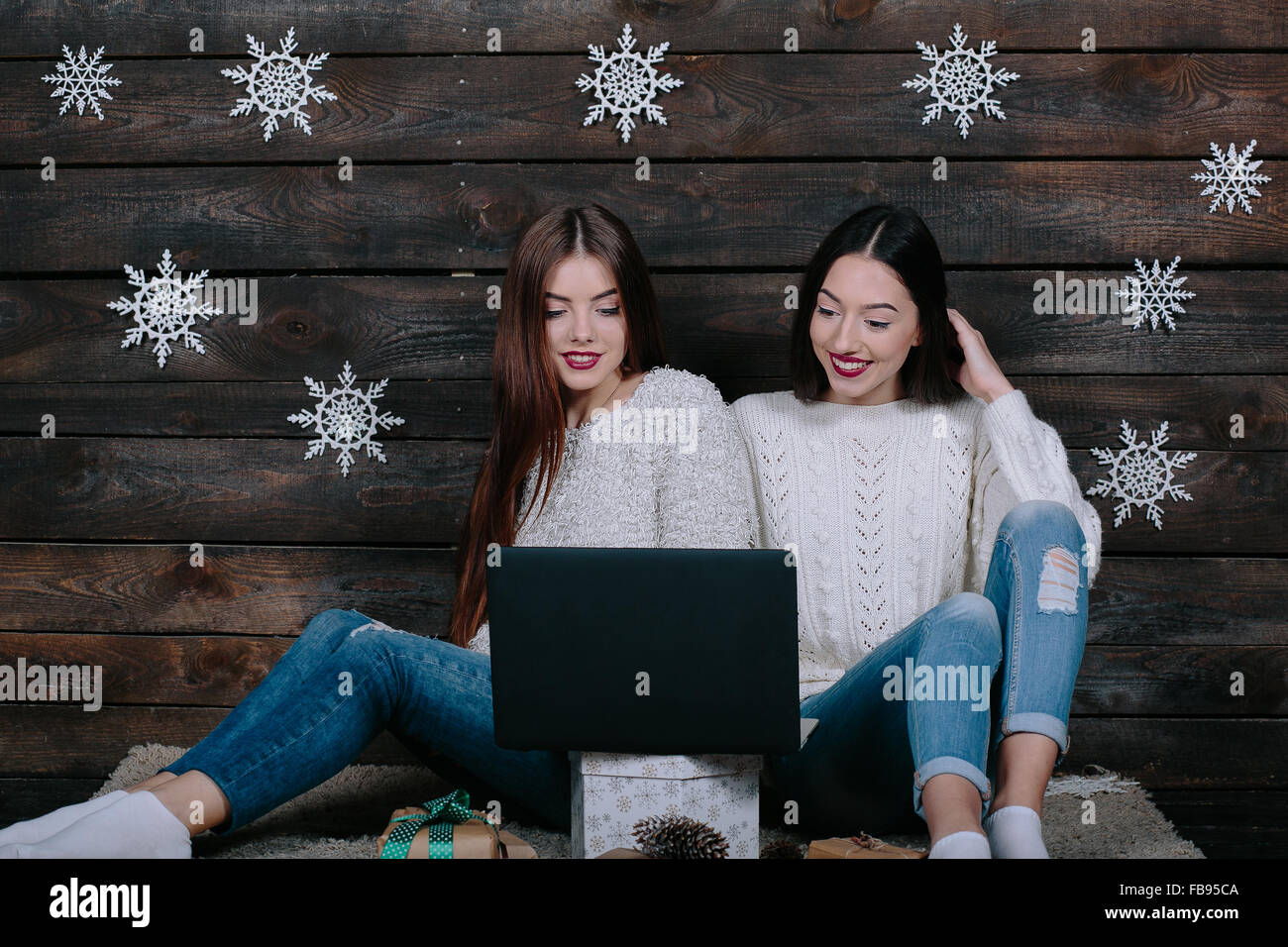 Two beautiful girls siting on the floor Stock Photo - Alamy