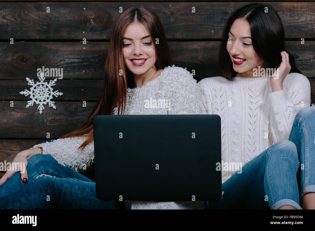 Two beautiful girls siting on the floor Stock Photo - Alamy