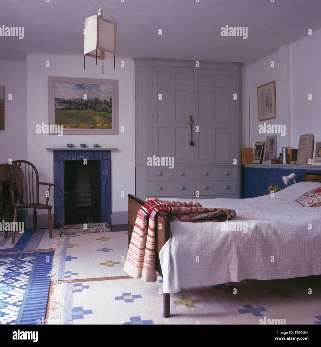 White Cotton Bedspread On Bed In White Bedroom With Blue