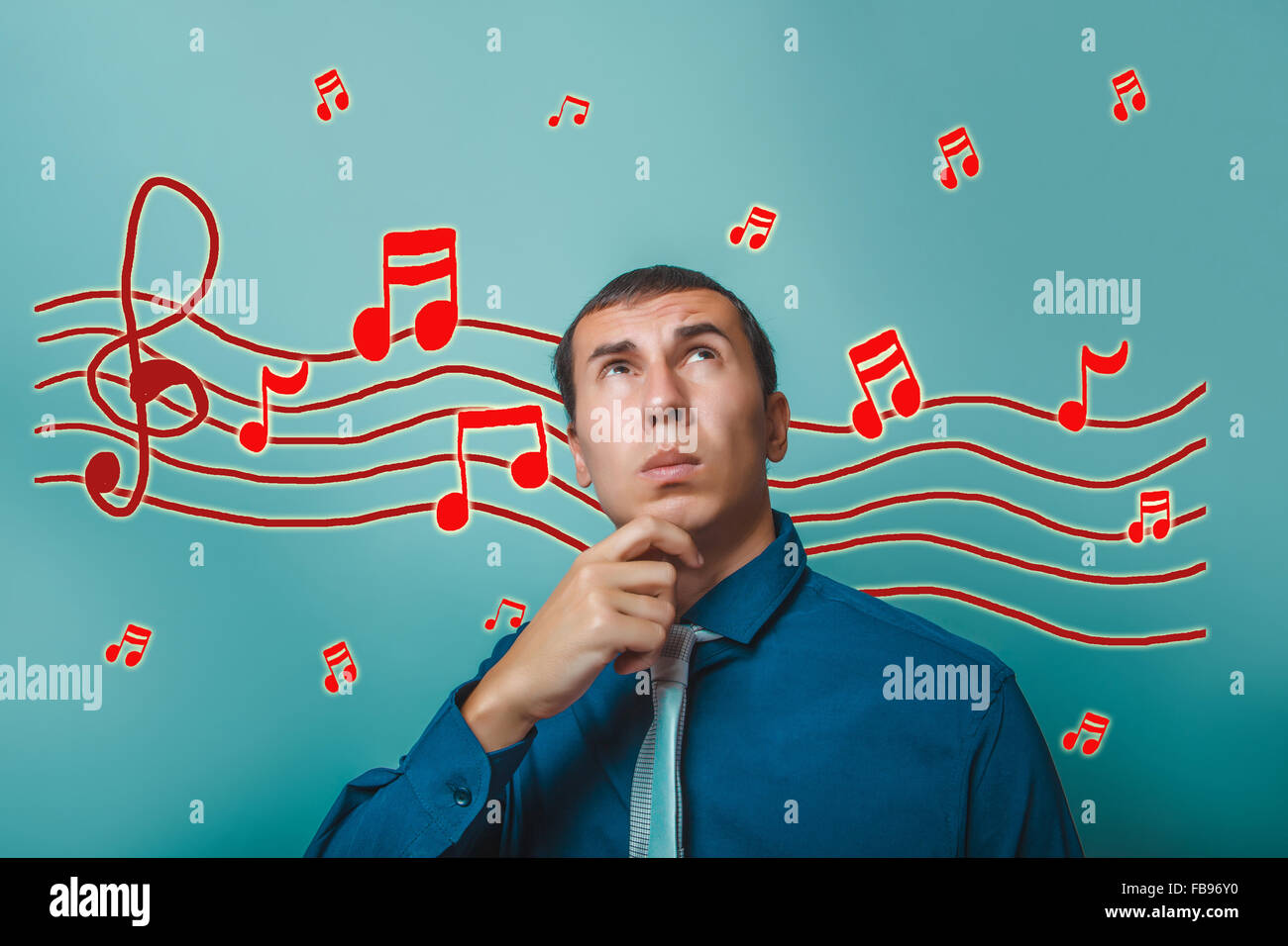 a male looking up thinking music notes sketch prevent sound Stock Photo