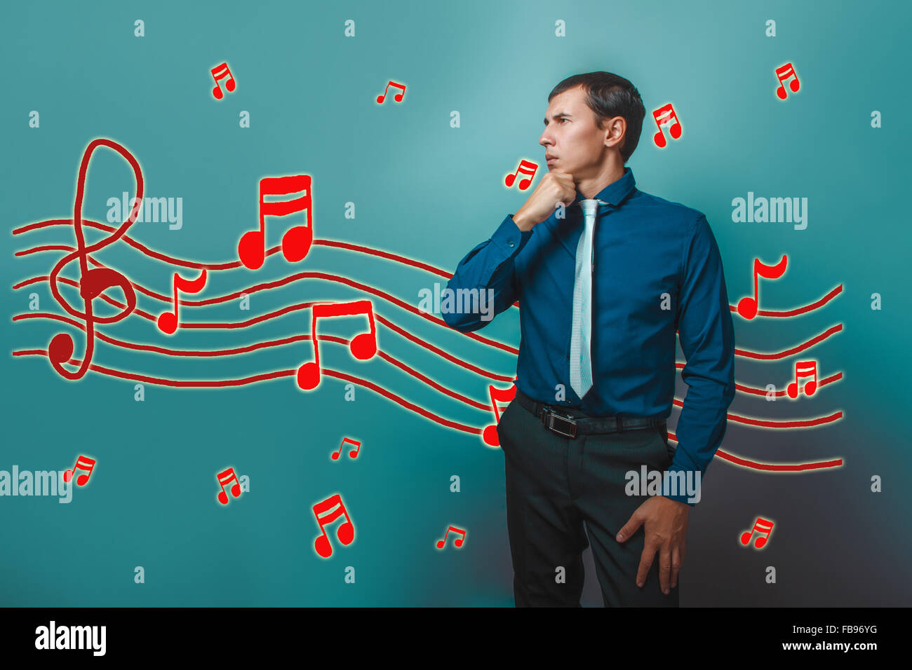 A man holds a hand to his chin music notes sketch prevent sound Stock Photo