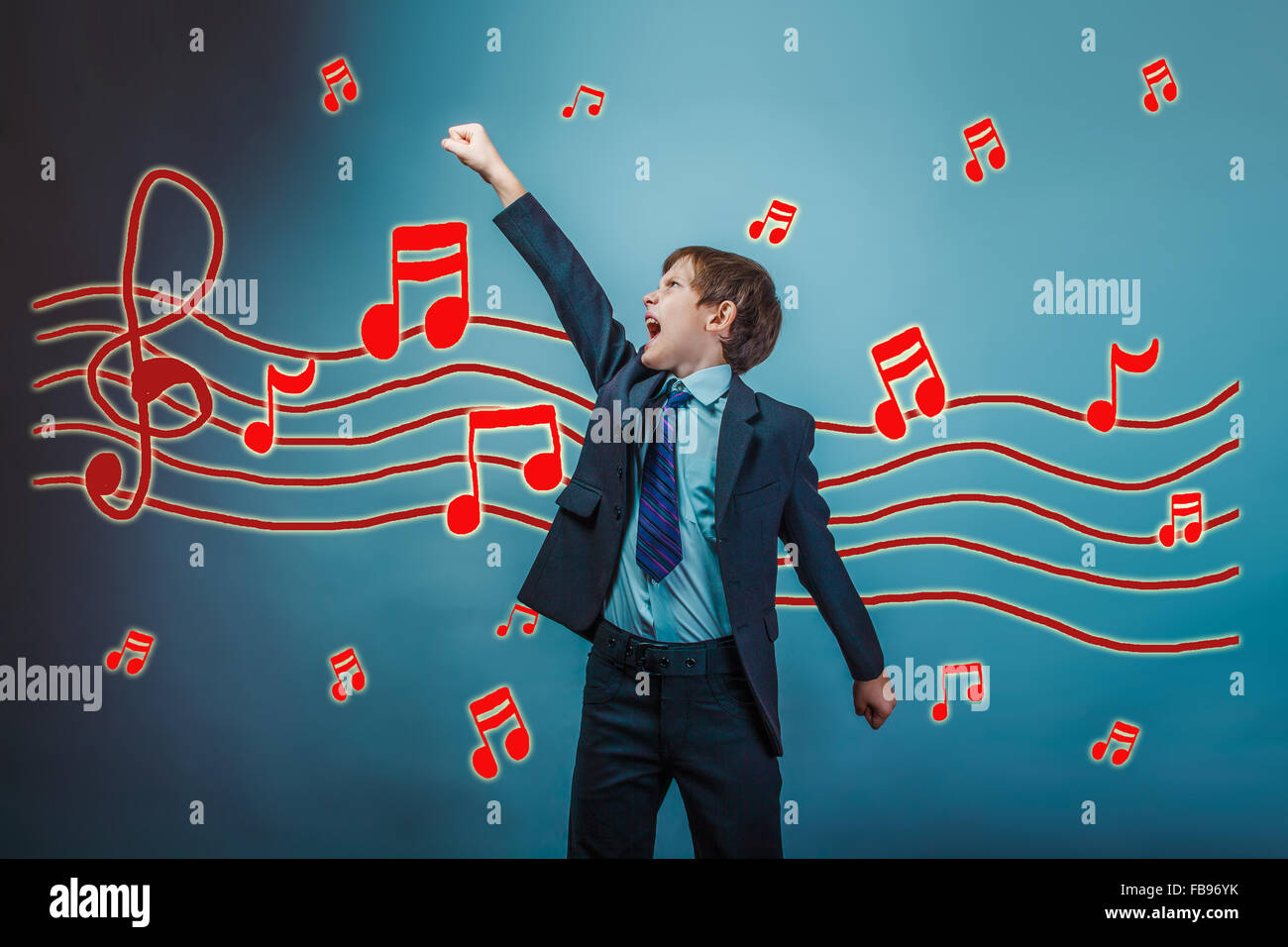 a teenager boy raised his hand up business style of music notes Stock Photo
