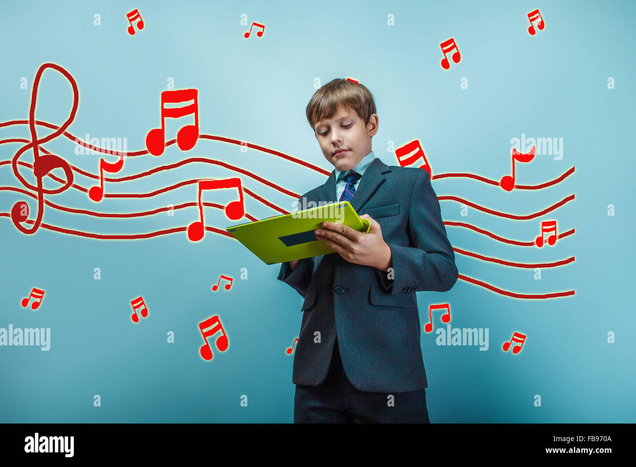 adolescent boy business style of music works on the tablet sketc Stock Photo