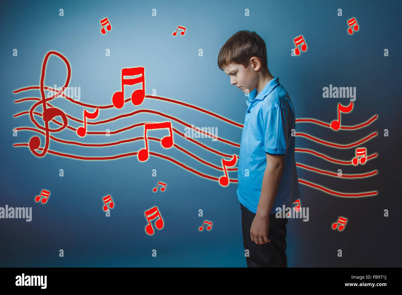 adolescent boy lowered his head to prevent the sheet music sketc Stock Photo