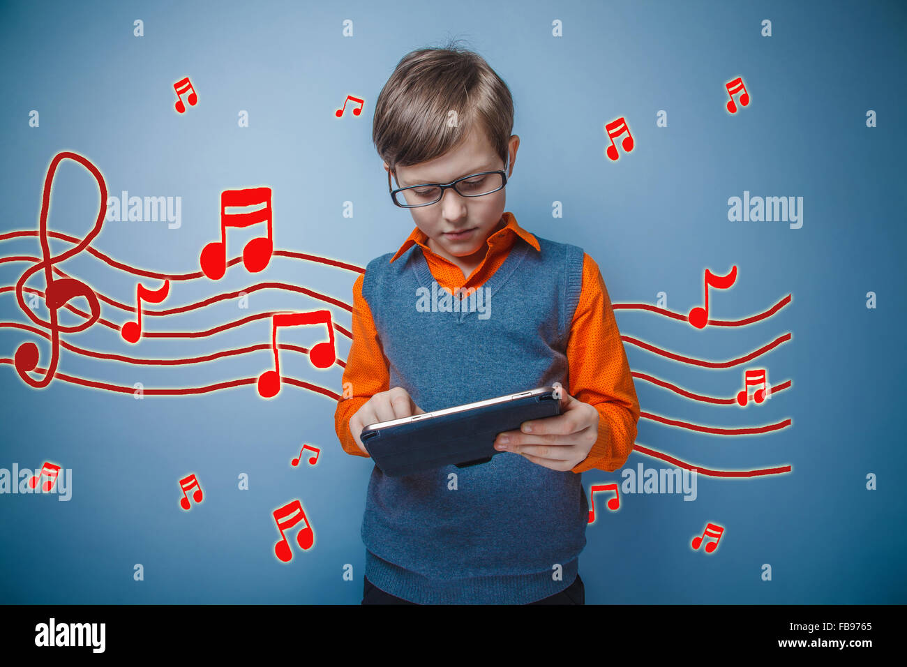 adolescent boy working on a tablet retro music notes sketch prev Stock Photo