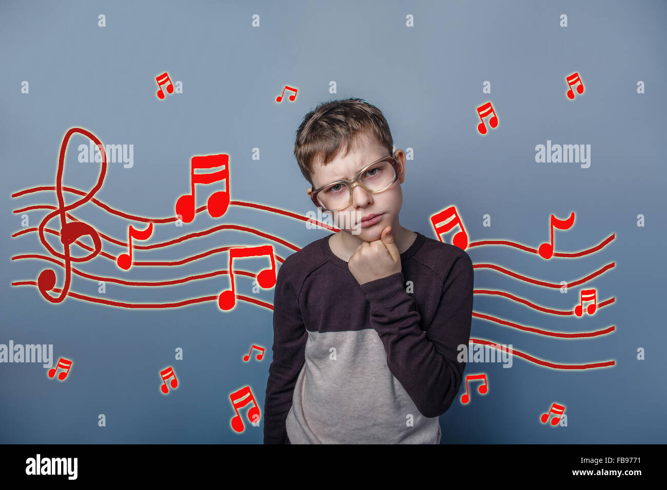 adolescent the boy in glasses thinking music notes sketch preven Stock Photo