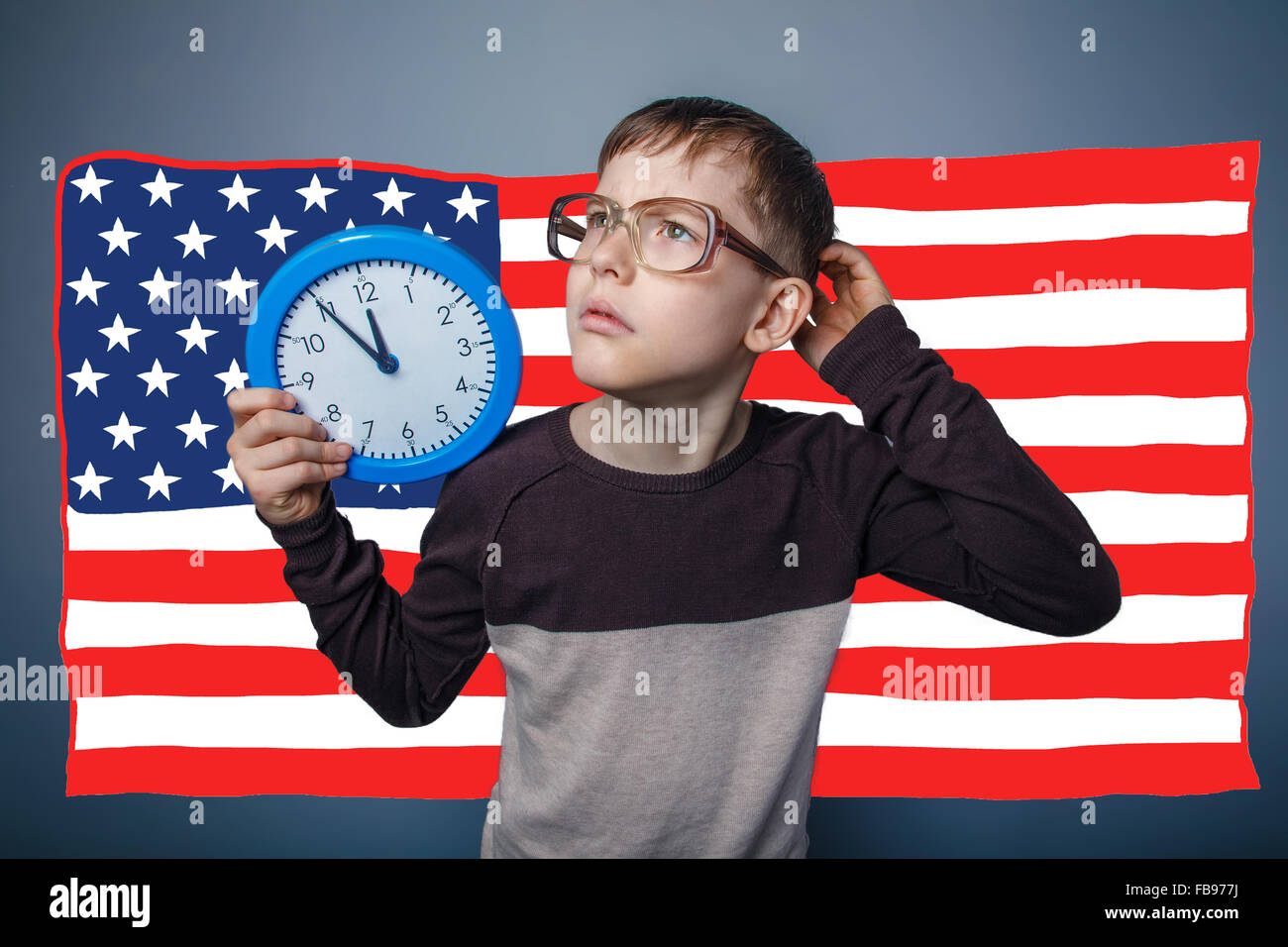 adolescent the boy wearing glasses and holding an American flag Stock Photo