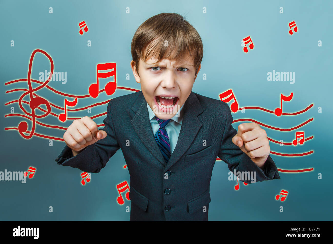 business style of teen boy clenched his fists and screaming musi Stock Photo