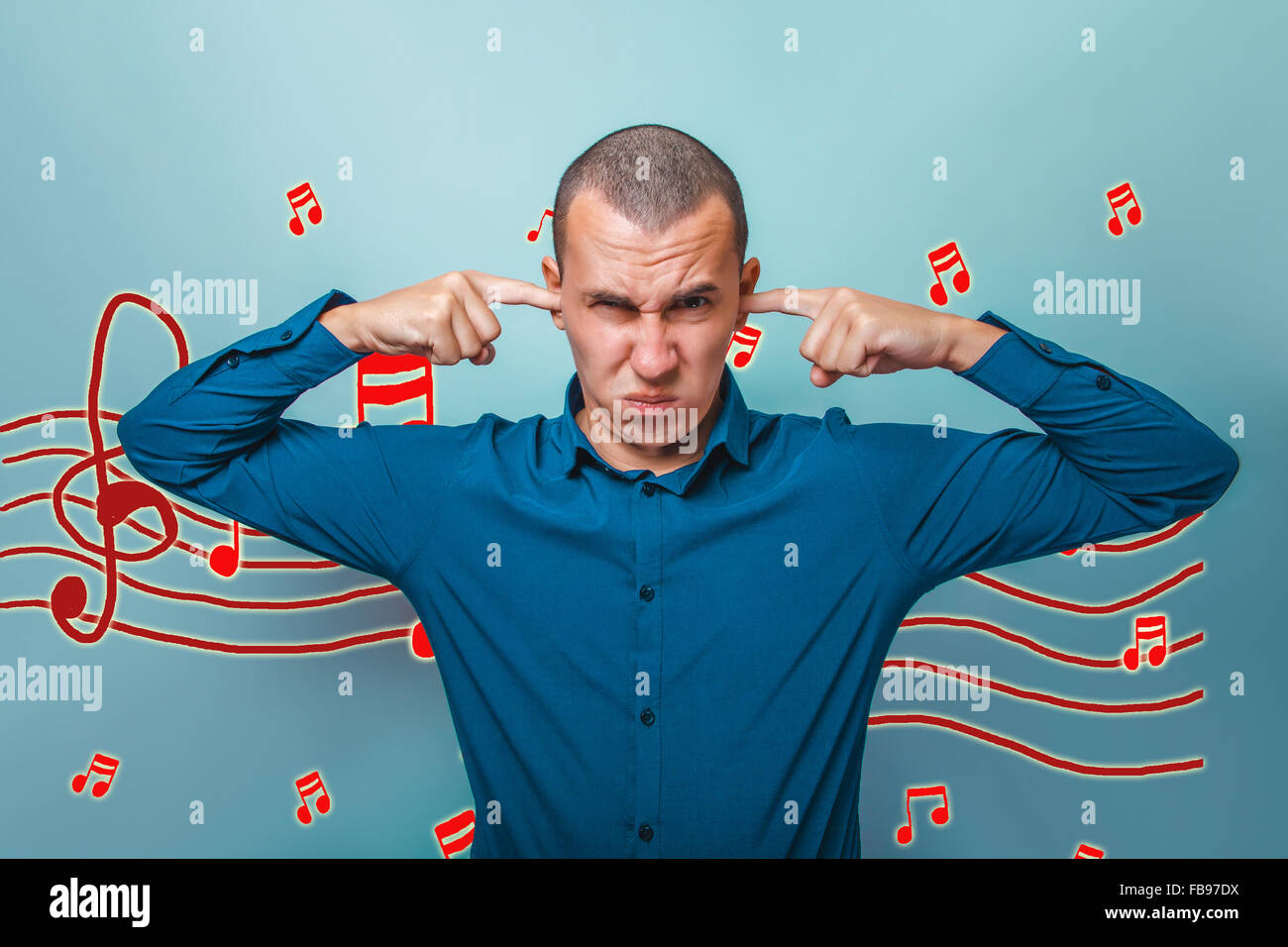 businessman a man put his fingers in his ears the evil music not Stock Photo