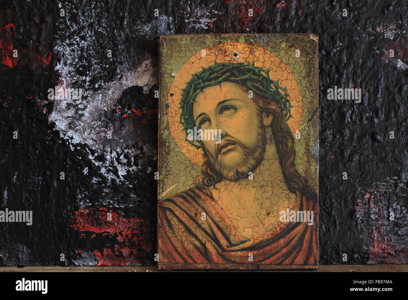 Jesus Christ portrait, Crowned with Thorns, painting photo against dark paint background,Norwich,Norfolk,UK Stock Photo