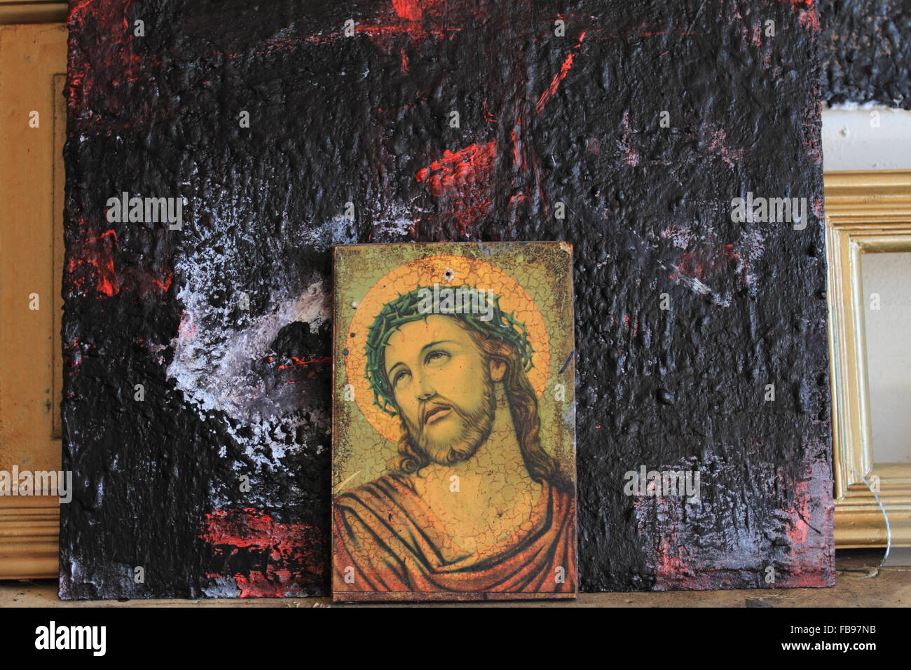 Jesus Christ portrait, Crowned with Thorns, painting photo against dark paint background,Norwich,Norfolk,UK Stock Photo