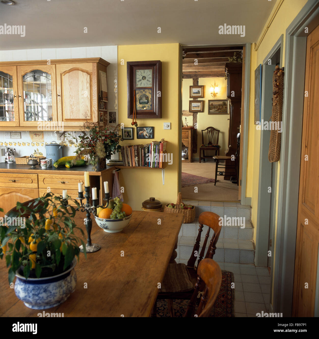 Yellow crockery in nineties economy kitchen with turquoise doors on fitted  units Stock Photo - Alamy