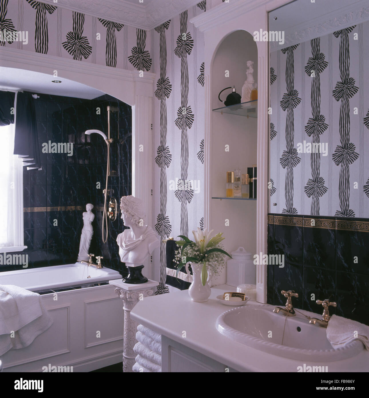 Black+white ribbon wallpaper in nineties bathroom with a classical bust Stock Photo