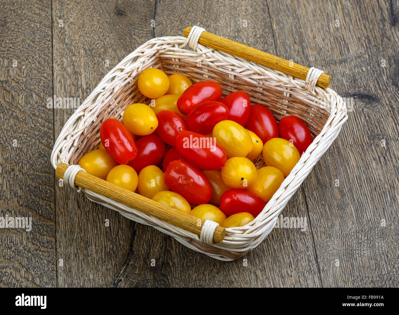 Yellow and red cherry tomatoes mix on the basket Stock Photo - Alamy