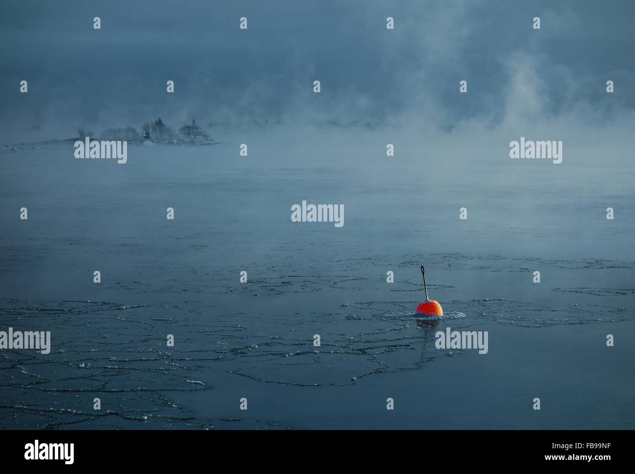 Red buoy in the freezing Baltic Sea in Helsinki, Finland Stock Photo