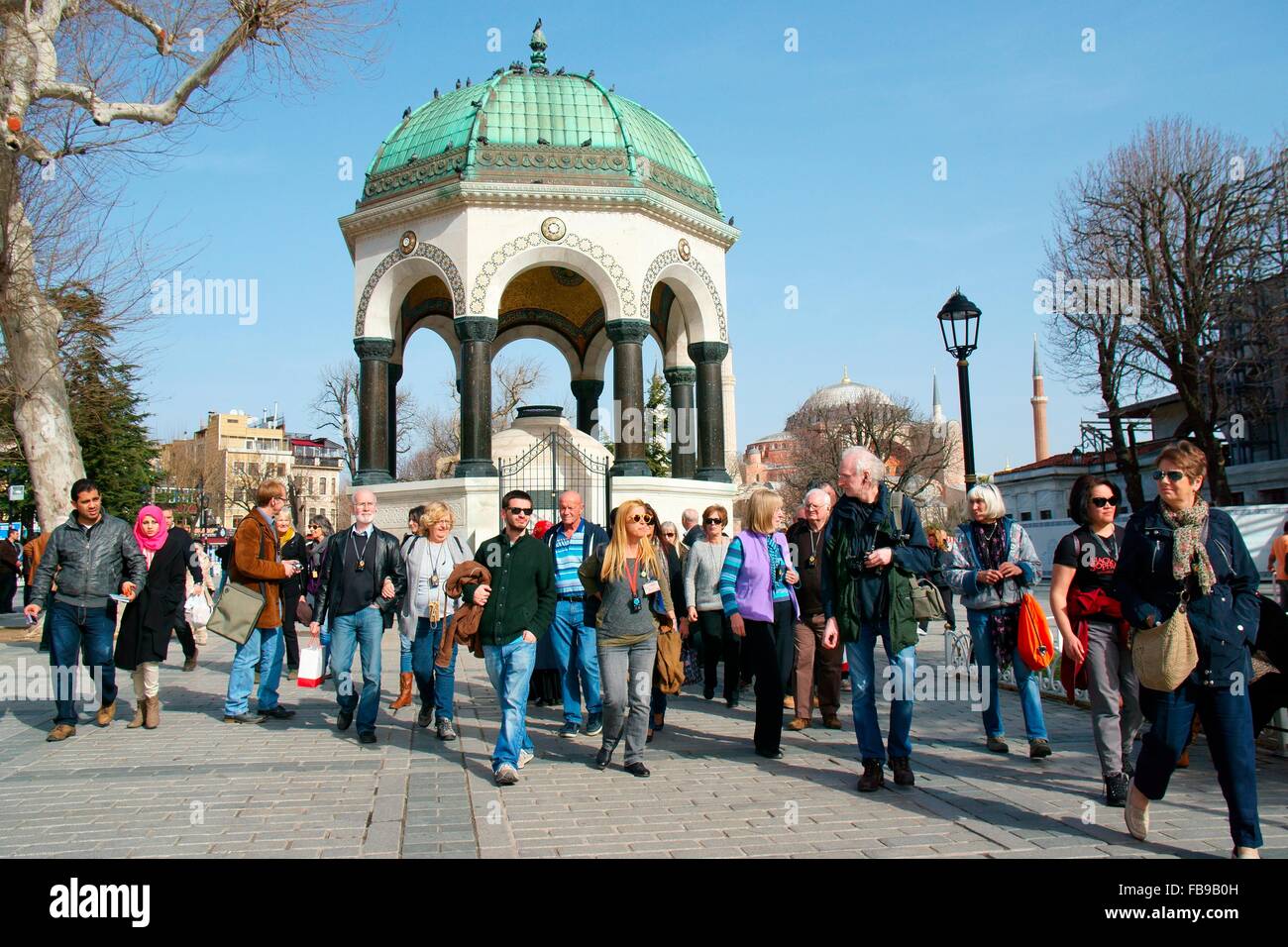 Istanbul, Turkey. Tourists tourist party tour group in front of the German Fountain in Sultan Ahmet Square aka the Hippodrome Stock Photo