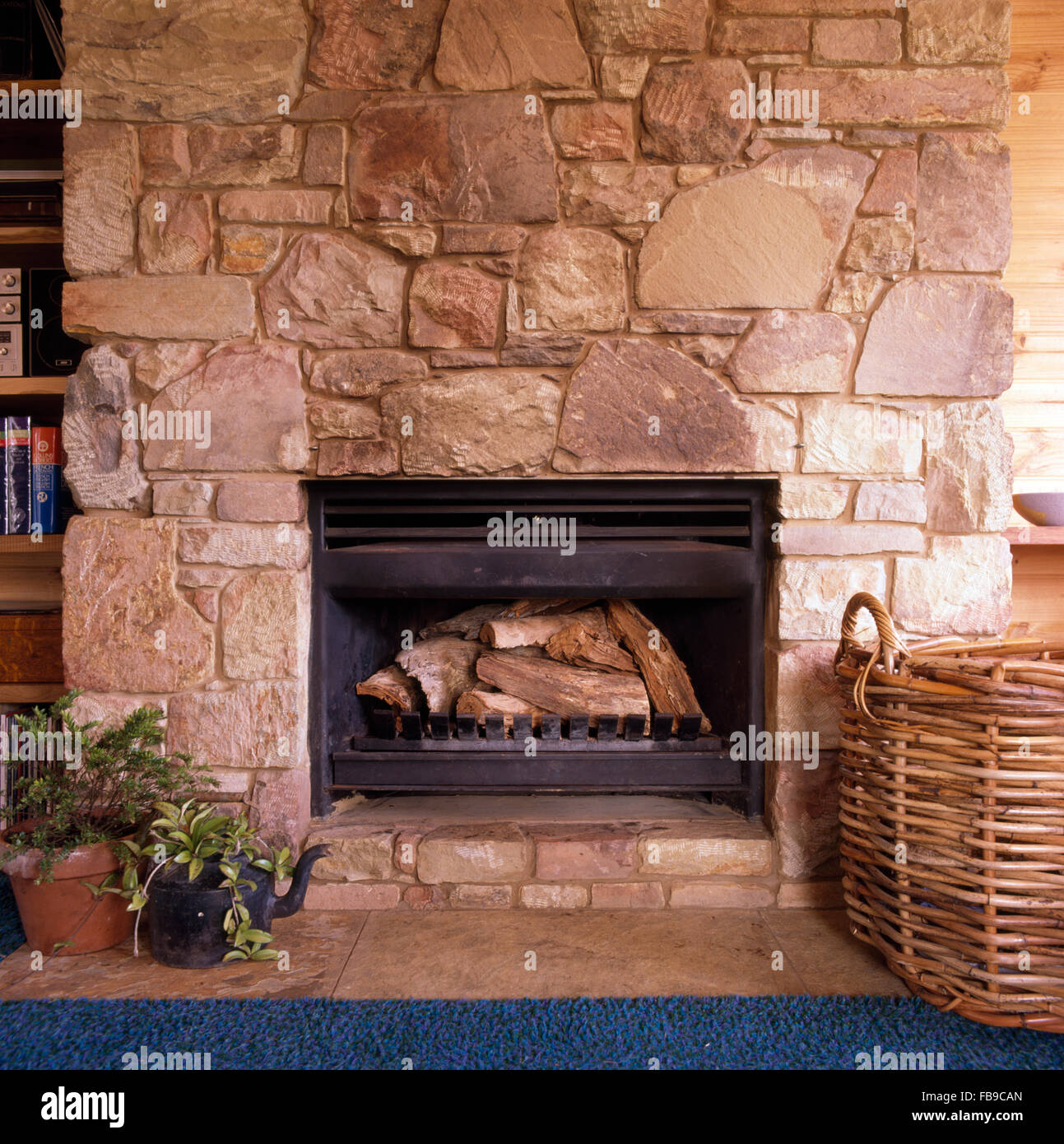 Close-up of fireplace in rough stone wall Stock Photo
