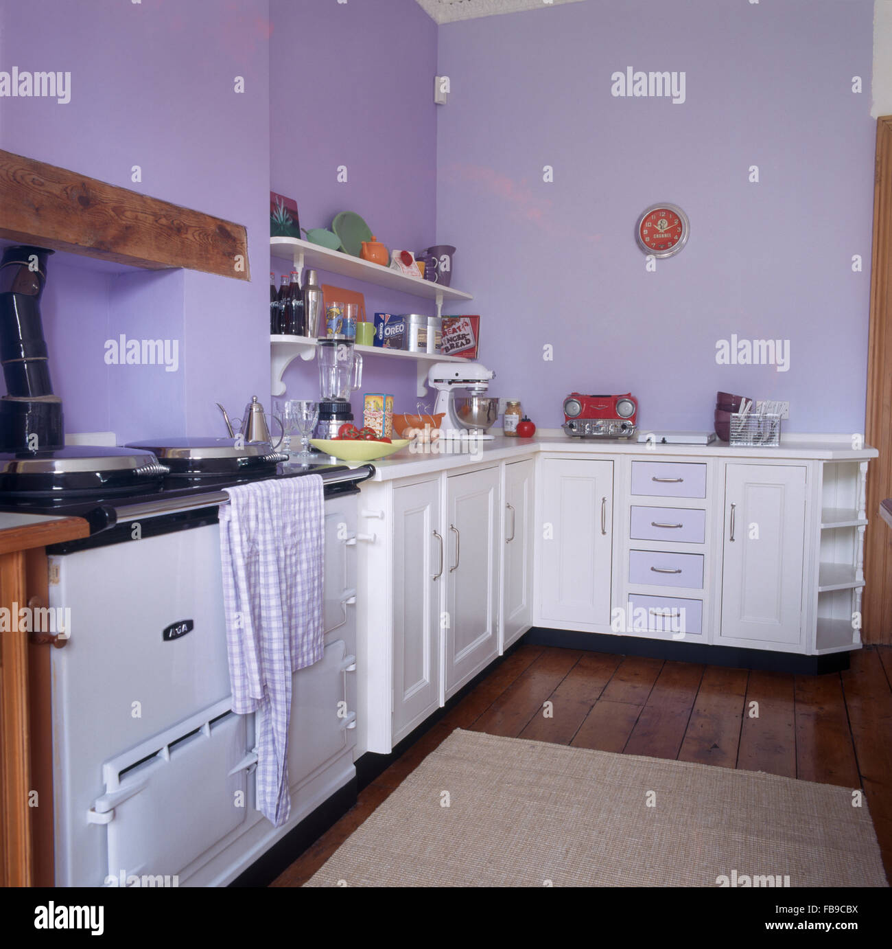 White Aga oven in pale mauve kitchen with white fitted units Stock Photo